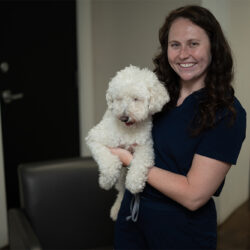 Dr. Anna Naguszewski, DVM, holding a white poodle